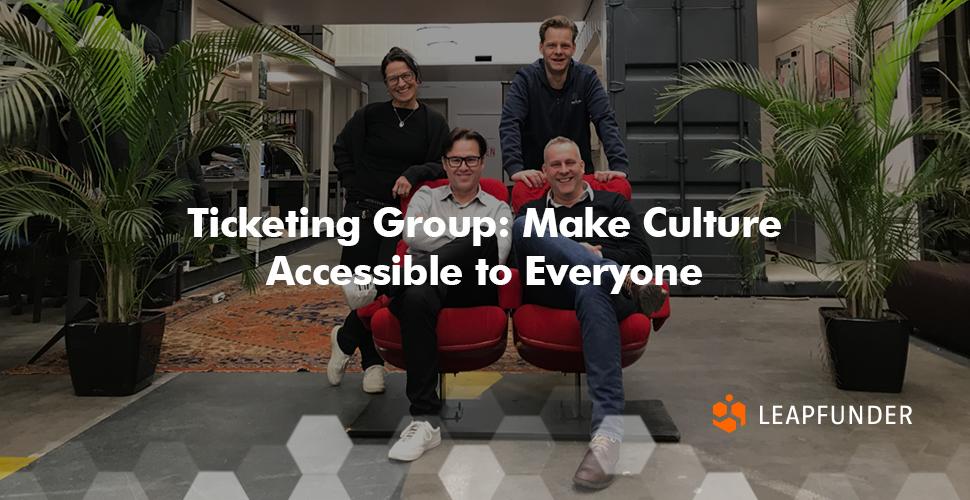 Ticketing Group team sitting on red chairs in a coworking space