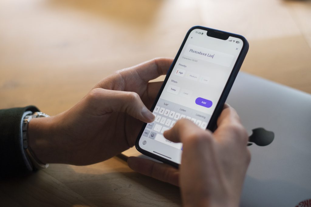 Man's hands typing on cellphone