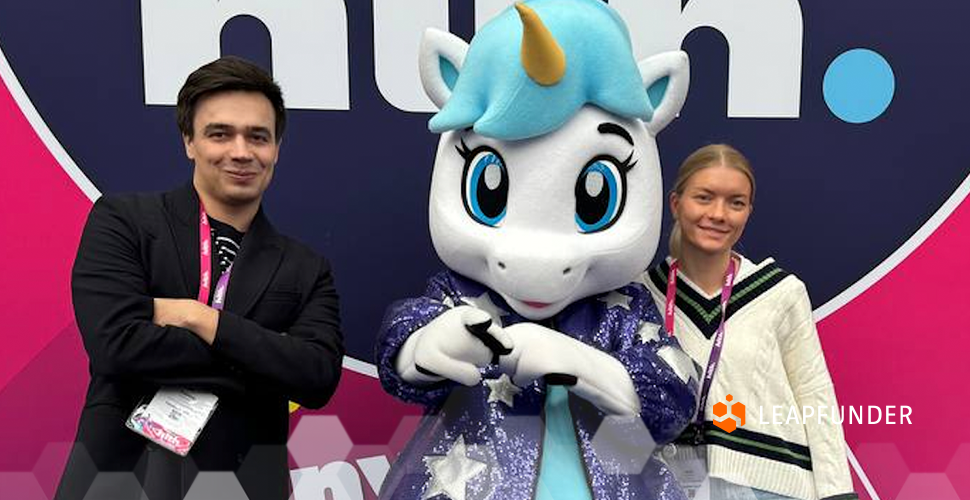 Two people posing with a unicorn